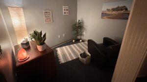 Photo of relaxation space with salt lamp, chair, plants